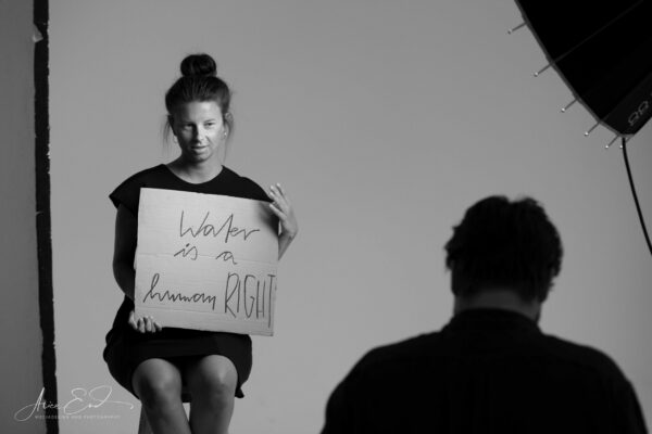 Eine Frau hält ein Schild mit der Aufschrift "water is a human Right"